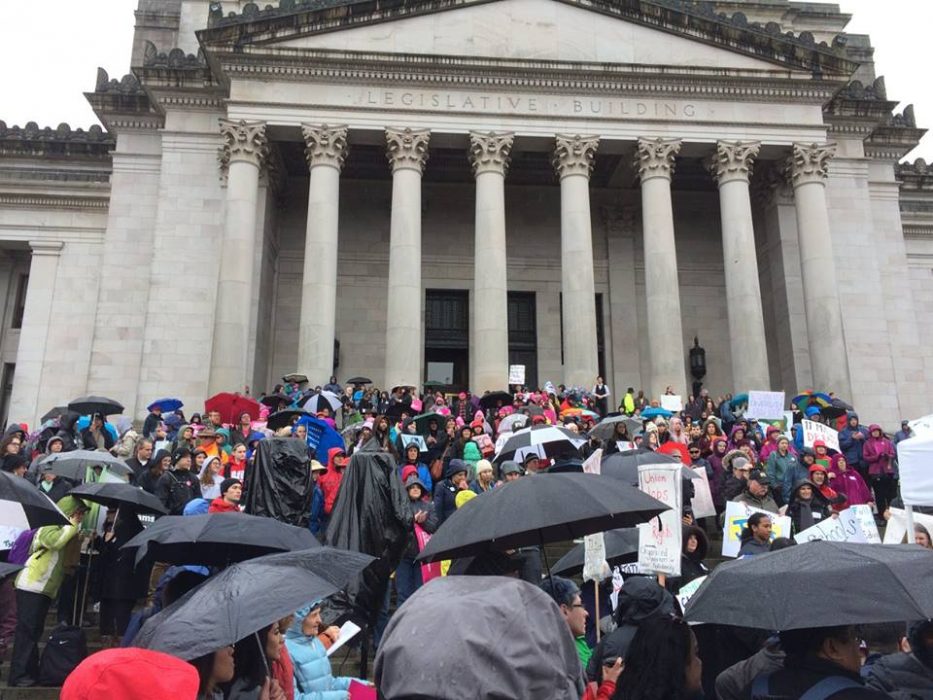 A crowd of people at a rally at the capitol in Olympia, WA