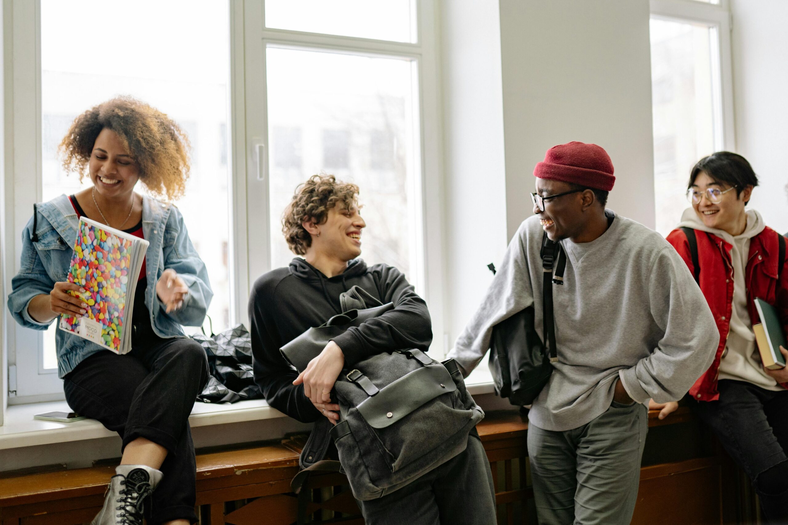 A group of young people at school smiling at each other